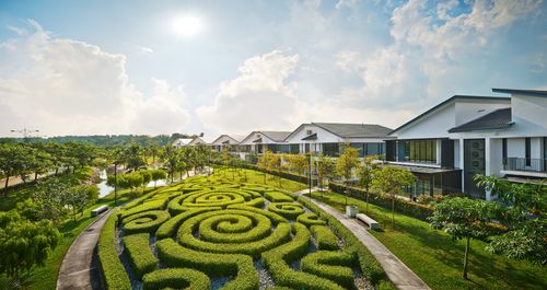 An artistic hedge garden alongside a row of houses at Senibong Cove.